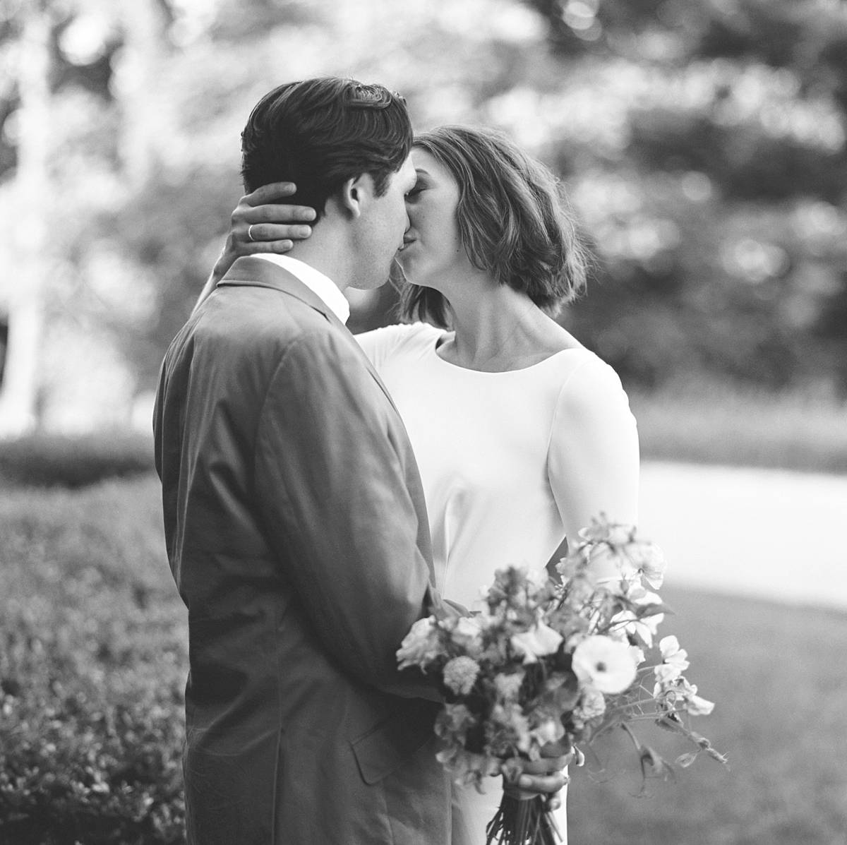 bride and groom kissing on black and white film shot on hasselblad with 110mm f2 lens